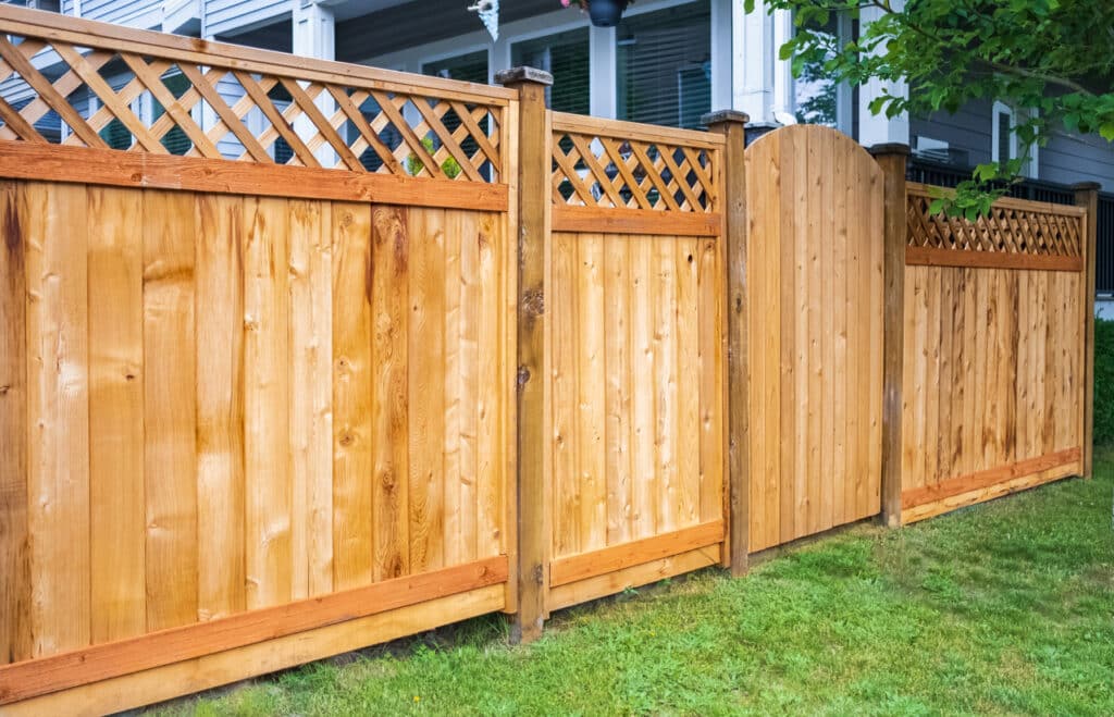 Wooden fence with green lawn