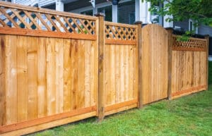 Wooden fence with green lawn